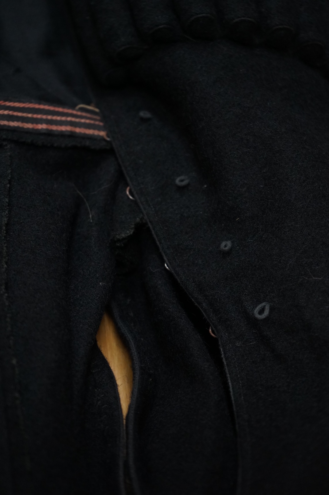 A theatrical gents black wool coat, with unusual pocket detail. 120cm long